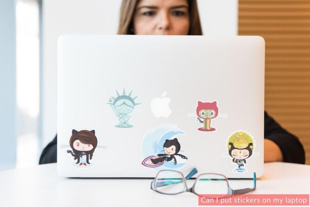 A women thinking about sticker on laptop